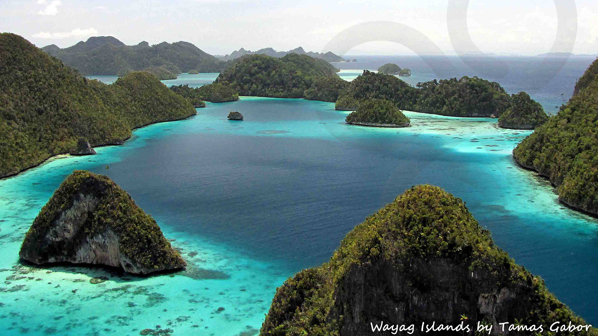 This panoramic view of limestone pinnacles and deeply undercut, toadstool-shaped islets in the Wayag group off northwestern Waigeo Island has become an iconic image of Raja Ampat. Copyright © Tamas Gabor