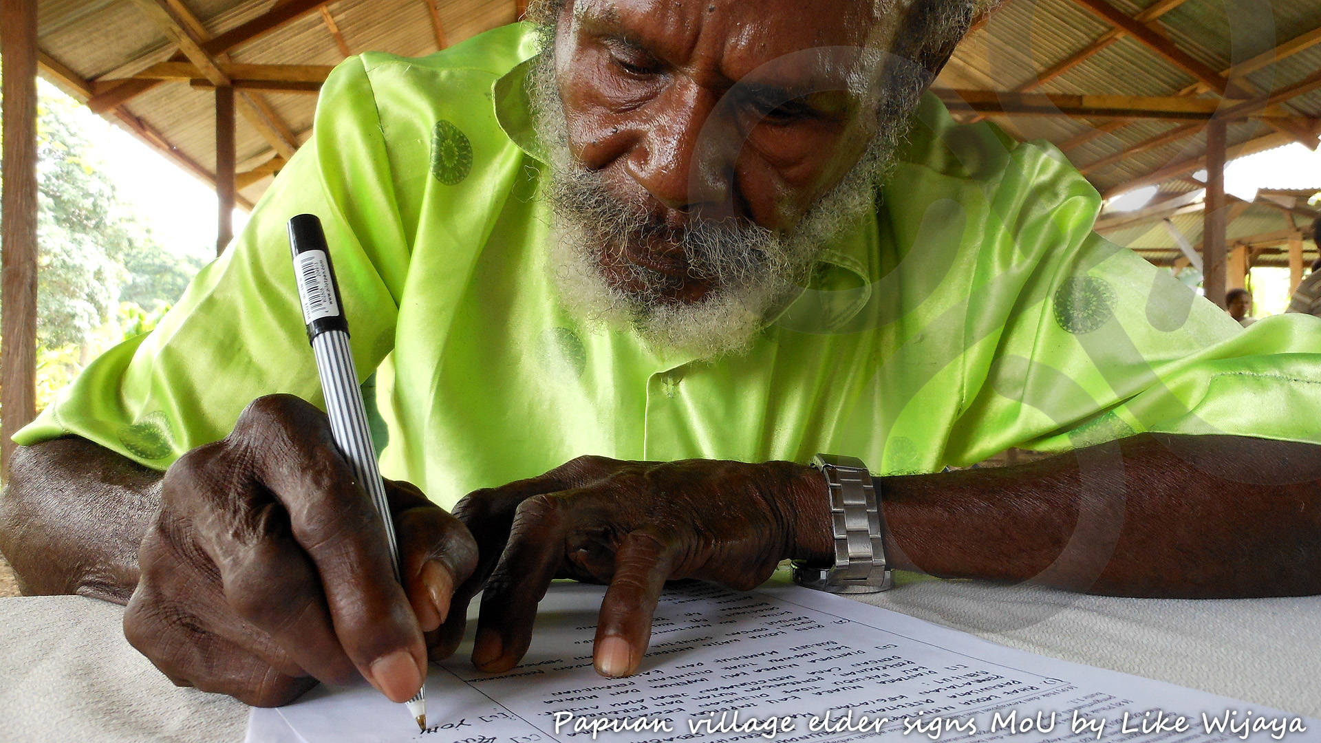 A Papuan village elder signs a Memory of Understanding with Papua Expeditions to deploy essentially non-invasive ecotourism activities on ancestral lands, thereby laying out the best possible framework for continuous visitation. Copyright © Like Wijaya